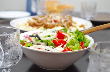 Freshly prepared Greek salad on a serve table closeup