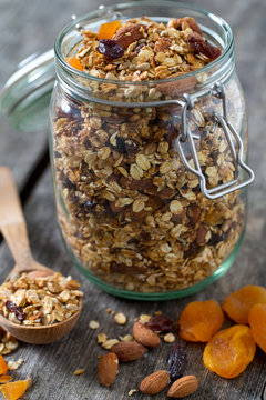 Granola In Glass Jar On Wooden Table