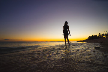 woman relaxing under the sunset at seaside