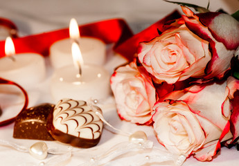 Valentines day. Roses with candles and sweets