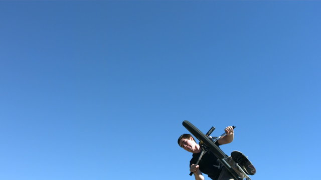 BMX rider flying into air, slow motion