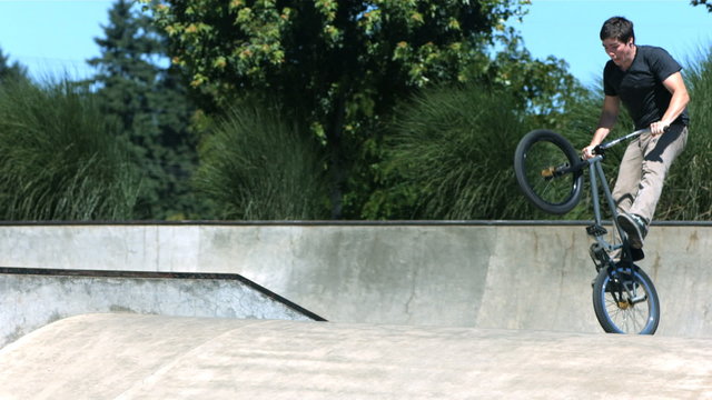 BMX rider doing a tail whip, slow motion