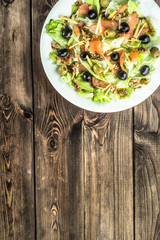 Mediterranean salad with salmon and olives.
