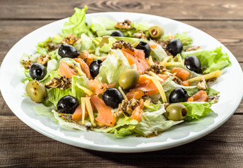Mediterranean salad with salmon and olives, selective focus