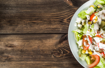 Colorful vegetable salad with tomato and lettuce.