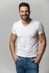 Handsome young man,boy,posing in white t shirt and jeans with ha