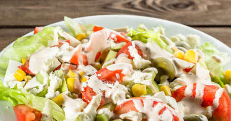 Colorful vegetable salad with tomato and lettuce.