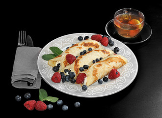 pancakes with cottage cheese and berries. transparent Cup with t