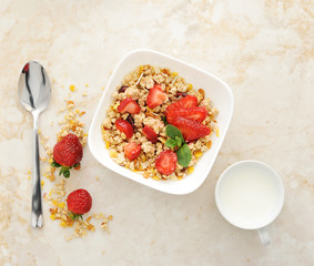 Muesli with cereals and strawberries. Mug of milk. Healthy food.