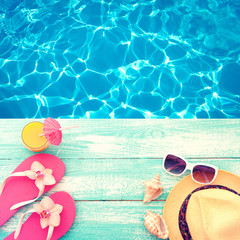 Summer Holidays in Beach Seashore. Fashion accessories summer flip flops, hat, sunglasses on bright...
