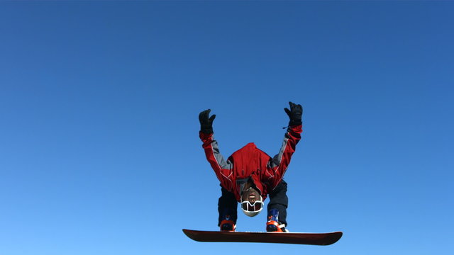 Snowboarder does backflip, slow motion