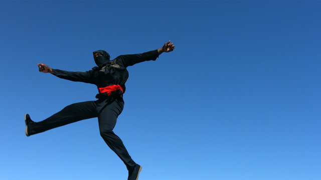 Ninja jumps in air and kicks, slow motion
