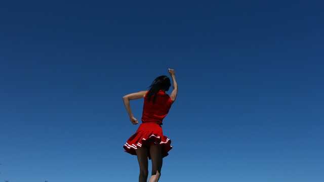 Cheerleader spinning in the air, slow motion