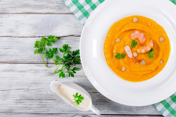 Pumpkin bisque With Prawns and chick pea, top view