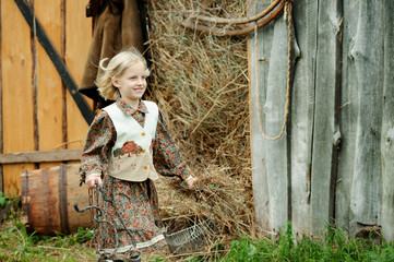 little girl in the village, carries the hay