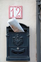 Mailbox on beige house wall number 12