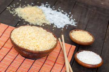 Natural brown and white rice in wooden bowls