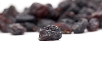 Black raisins on a white background. macro