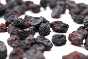 Black raisins on a white background. macro