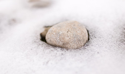 Fototapeta na wymiar stones in the snow on the nature