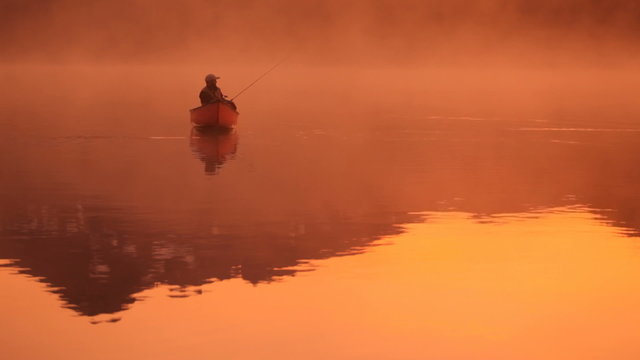 Fishing from canoe at sunrise