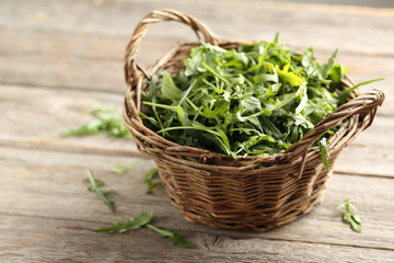Fresh arugula leafs on a grey wooden table