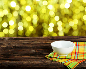 Background with wooden table with white bowl