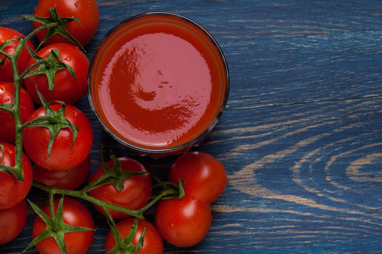 Fresh tomato juice on a blue background