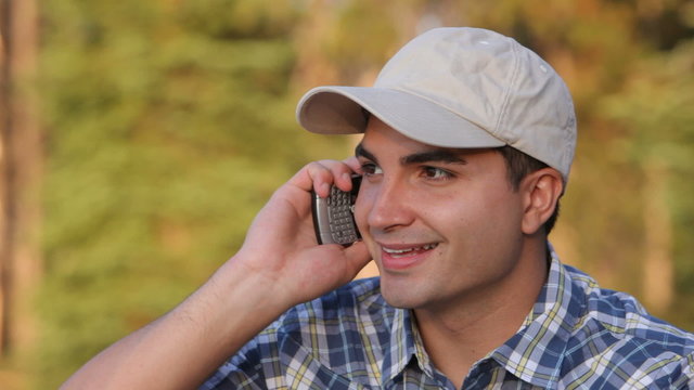 Young man outdoors taking on cell phone