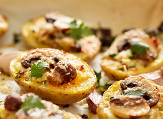 Baked potatoes stuffed with mushroom, onion, herbs and melted cheese
