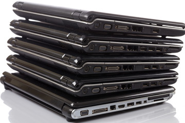 stack of old laptops awaiting repair