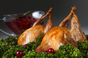 Carcasses of quail roasted with cranberry and parsley