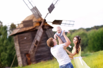 Obraz premium beautiful family with a baby in the park