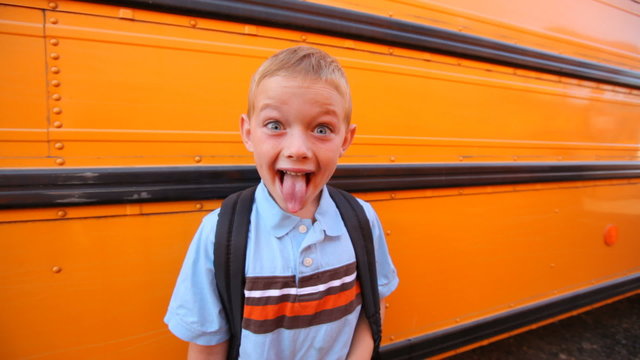 Excited school boy making faces