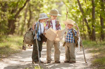Boys travelers exploring route map