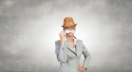 Businesswoman trying paper mustache