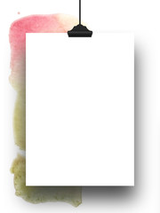 Close-up of one hanged paper sheet with clip on multicolour watercolour stain background