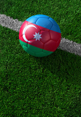 Fototapeta na wymiar Soccer ball and national flag of Azerbaijan, green grass
