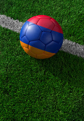 Fototapeta na wymiar Soccer ball and national flag of Armenia, green grass