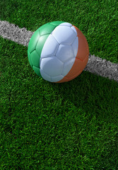 Fototapeta na wymiar Soccer ball and national flag of Ireland, green grass
