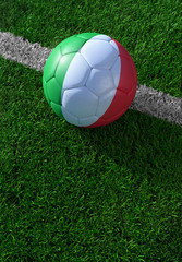 Fototapeta na wymiar Soccer ball and national flag of Italy, green grass