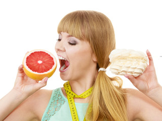 Woman choosing fruit or cake make dietary choice