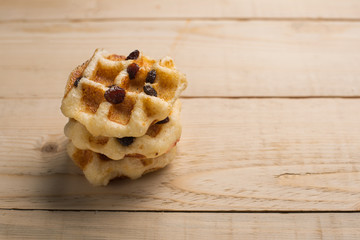 Waffle with raisin on wooden table