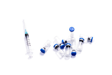 the syringe and set of the scattered ampoules with medicine for