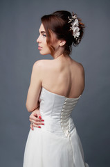 Fototapeta premium Elegant bride with short hair updo and bare shoulders dress