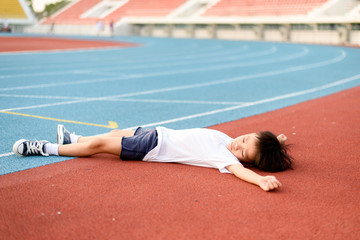 Boy lay on the running track