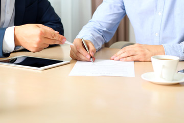 two colleagues is signing a contract, business meeting in the of