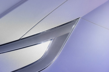Car headlight, fender and hood in ultra modern style of powerful sport racing sedan with silver and...