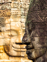 Ancient smiling stone face at Bayon Temple in Siem Reap, Cambodia