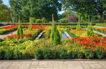 Fototapeta premium Colorful Flower Garden with Paths and Pond